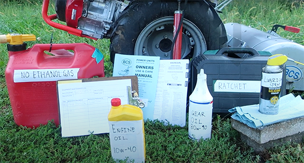 BCS machine surrounded by tools and materials needed for maintenance