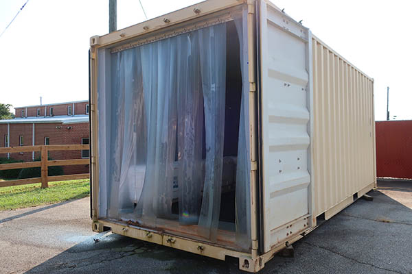 A crop storage room with plastic cooler curtains.