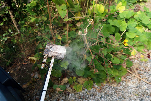 An oxalic acid vaporizer in use, spreading vapor.