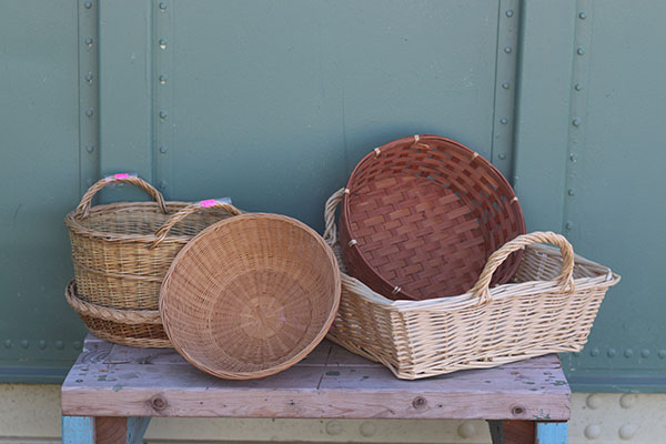 Several empty baskets are displayed on a table top.