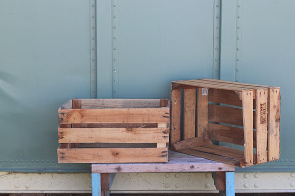 Two wooden crates are displayed on a table.
