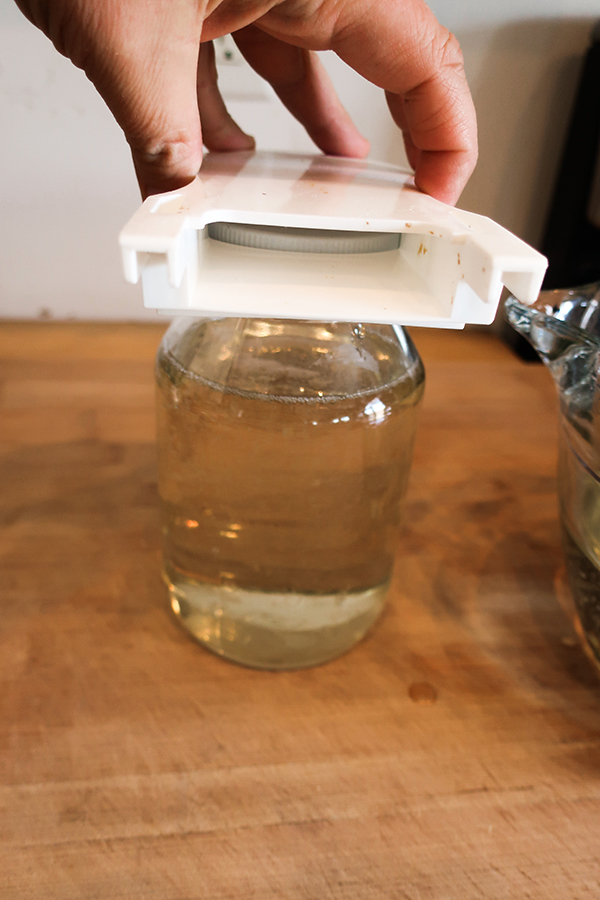 Filling an entrance feeder with sugar water