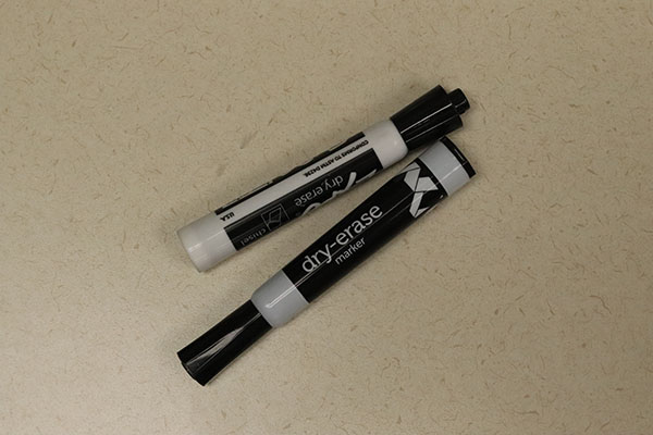 Two black dry-erase markers for writing price signs.