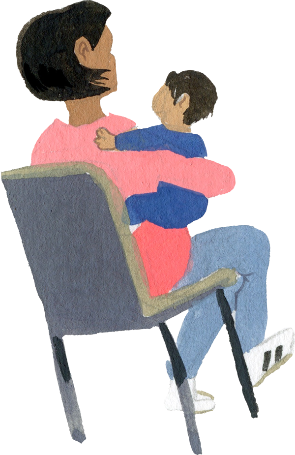 A woman sitting down in a chair with her child in her arms.