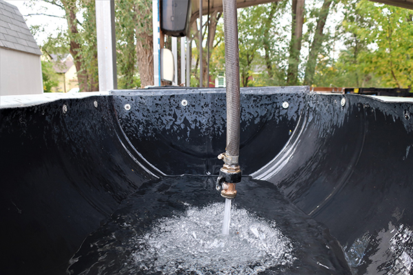 Filling wash station sink with water.