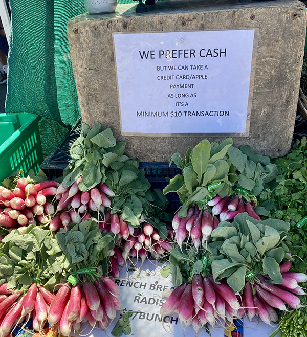 Cash Credit Sign at Market with Radishes